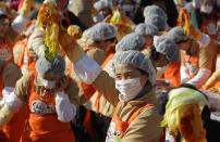 SEOUL, SOUTH KOREA - NOVEMBER 15: More than two thousands of housewives make Kimchi for donation to the poor in preparation for winter in front of City Hall on November 15, 2012 in Seoul, South Korea. Kimchi is a traditional Korean dish of fermented vegetables usually mixed with chili and eaten with rice or served as a side dish to a main meal. (Photo by Chung Sung-Jun/Getty Images)