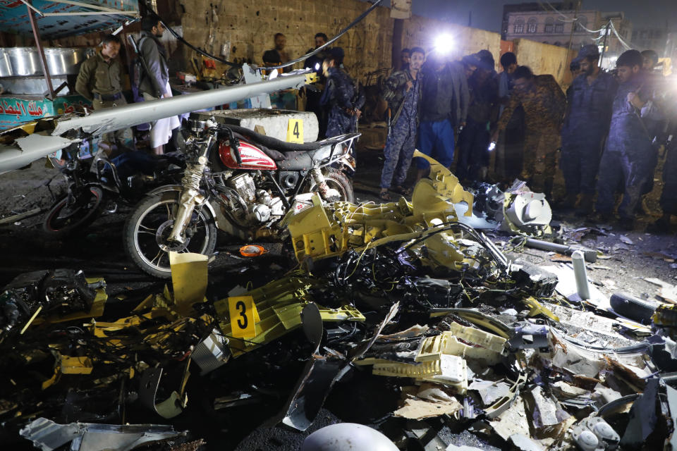 Soldiers stand near the wreckage of a drone aircraft which Houthi rebels claimed to have shot down, in Sanaa, Yemen, Monday, May 23, 2022. (AP Photo/Hani Mohammed)