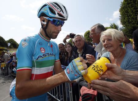 Astana rider Vincenzo Nibali of Italy signs autographs before the start of the 191.5-km (118.9 miles) 6th stage of the 102nd Tour de France cycling race from Abbeville to Le Havre, France, July 9, 2015. REUTERS/Eric Gaillard