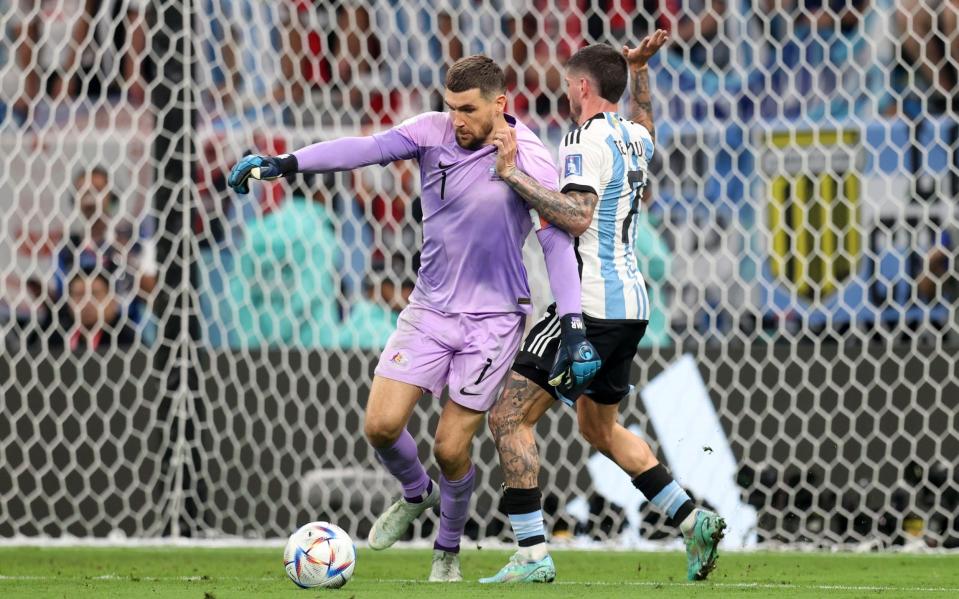 Mathew Ryan of Australia defends the ball against Rodrigo De Paul of Argentina during the FIFA World Cup Qatar 2022 Round of 16 match between Argentina and Australia at Ahmad Bin Ali Stadium - Getty Images