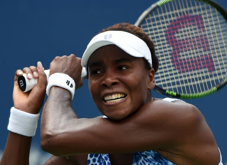 Venus Williams of the US returns a shot to Monica Puig of Puerto Rico during their US Open women's singles match on August 31, 2015 in New York