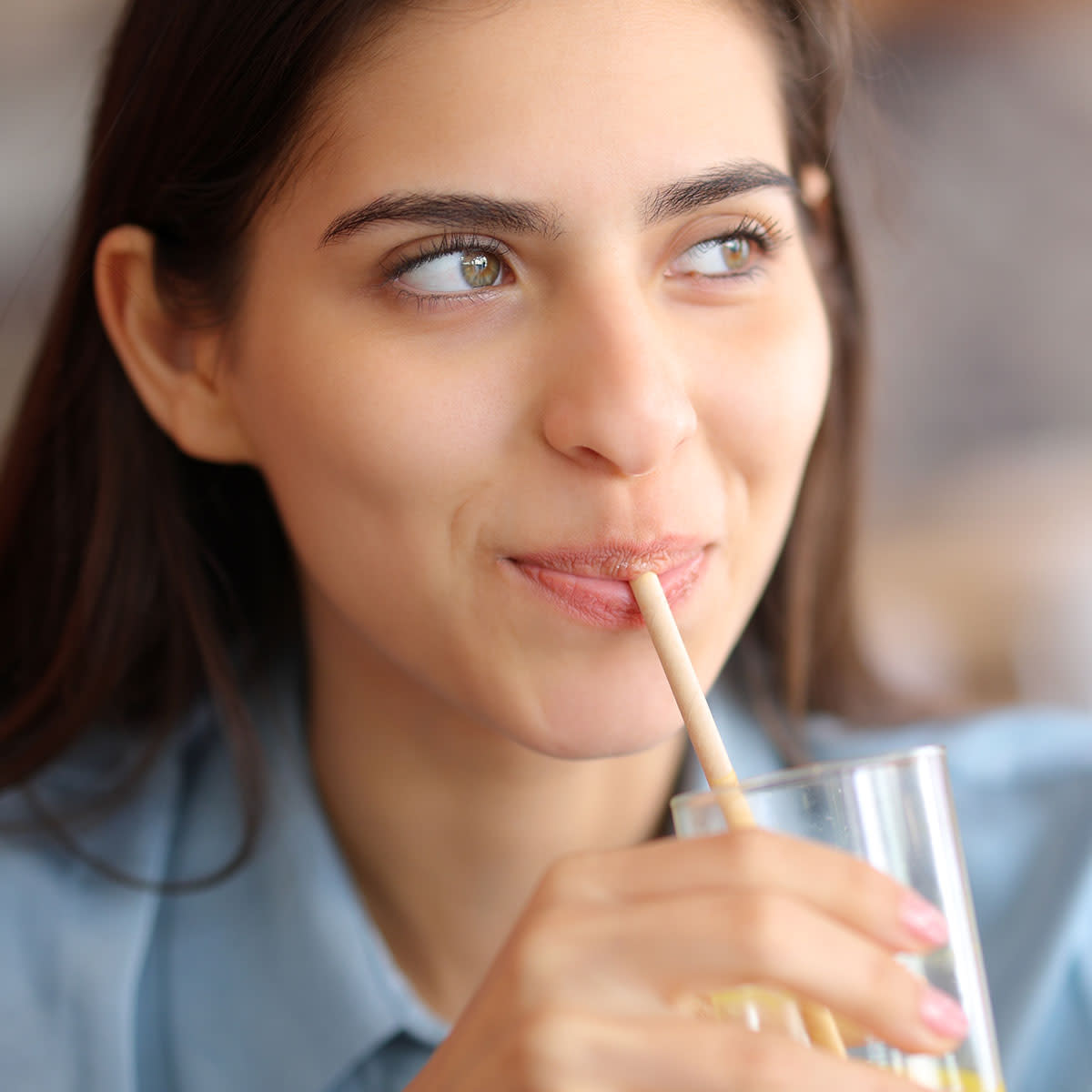happy woman sipping a beverage