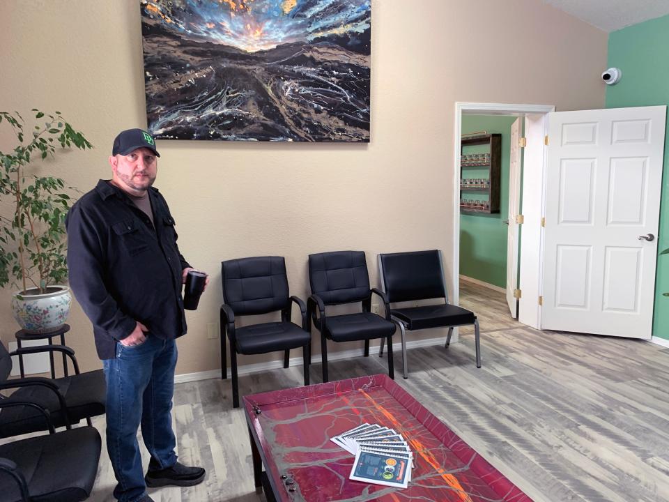 Justin Lewis, a partner in Distinguished Dispensary, stands in the waiting area of the Farmington, N.M. business.