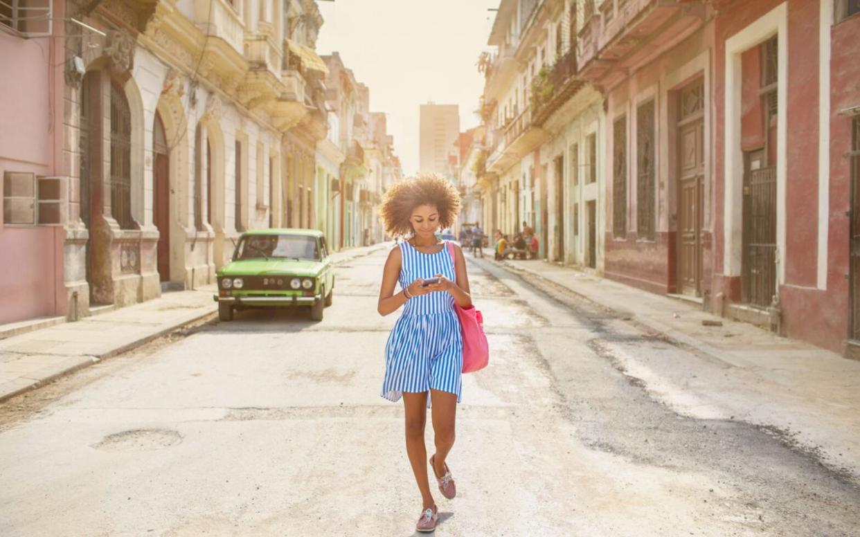 woman walking in street in Cuba - best urban adventures in Latin America