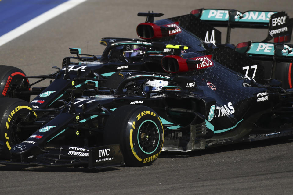 Mercedes driver Valtteri Bottas of Finland, right and Mercedes driver Lewis Hamilton of Britain steer their cars during the Russian Formula One Grand Prix, at the Sochi Autodrom circuit, in Sochi, Russia, Sunday, Sept. 27, 2020. (Bryn Lennon, Pool via AP)