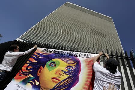 Protesters place a banner on a fence in the perimeter of the Senate building as they take part in a rally held the day before the start of the 2015 Paris Climate Change Conference (COP21), in Mexico City, Mexico November 29, 2015. The banner reads, "Global climate march-Mexico 2015". REUTERS/Daniel Becerril