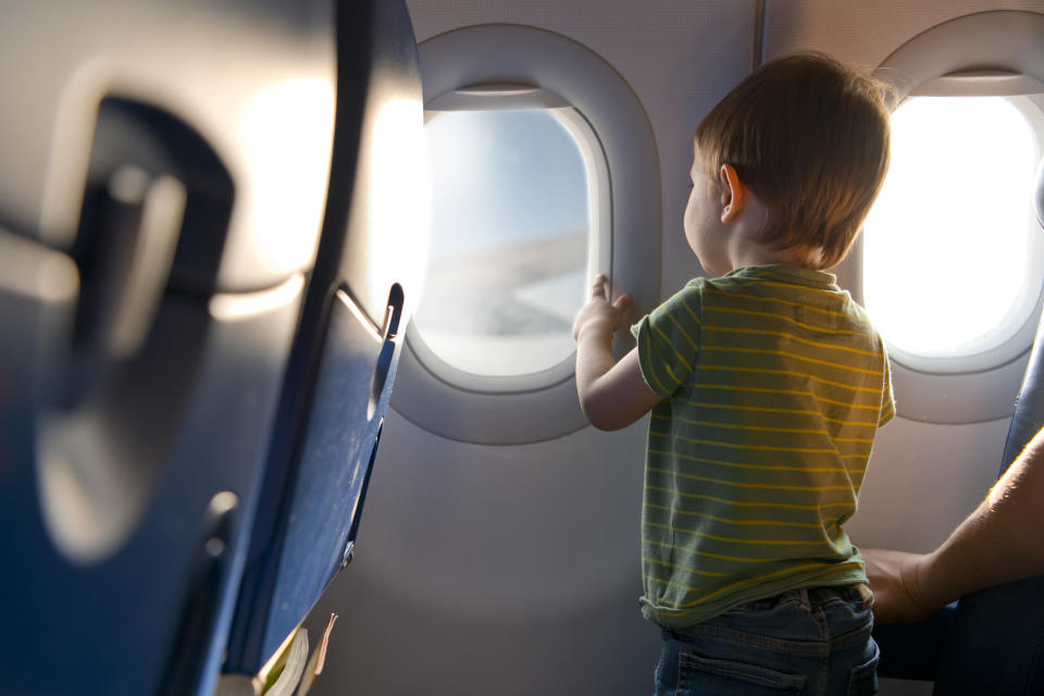 A child looking out an airplane window