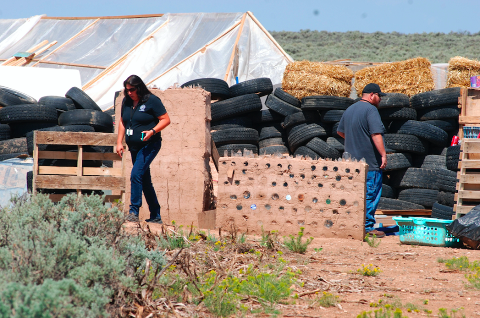 <em>Taos County Planning Department officials Rachel Romero (l) and Eric Montoya survey the property conditions (AP)</em>