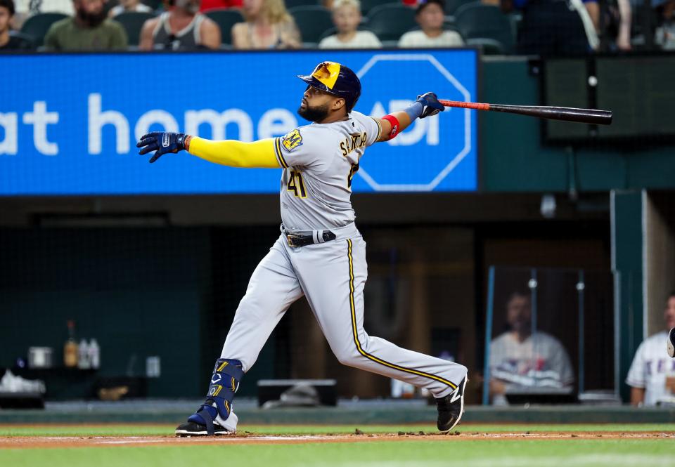 Brewers first baseman Carlos Santana hits a home run during the first inning against the Rangers at Globe Life Field.