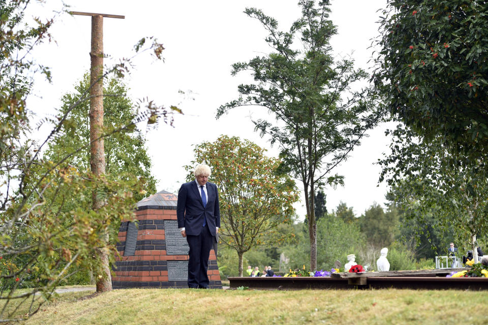 Britain's Prime Minister Boris Johnson lays a wreath at the Royal British Legion Service of Commemoration at the Sumatra Railway Memorial during the national service of remembrance marking the 75th anniversary of V-J Day at the National Memorial Arboretum in Alrewas, England, Saturday Aug. 15, 2020. Following the surrender of the Nazis on May 8, 1945, V-E Day, Allied troops carried on fighting the Japanese until an armistice was declared on Aug. 15, 1945. (Anthony Devlin/PA via AP)