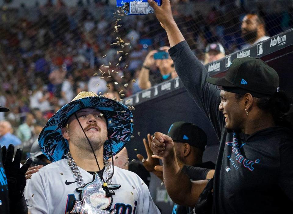 Miami Marlins third baseman Jake Burger (36) gets sunflowers seeds poured on him to celebrate his home run during the seventh inning of a baseball game on Sunday, Sept. 17, 2023, at loanDepot Park in Miami, Fla.