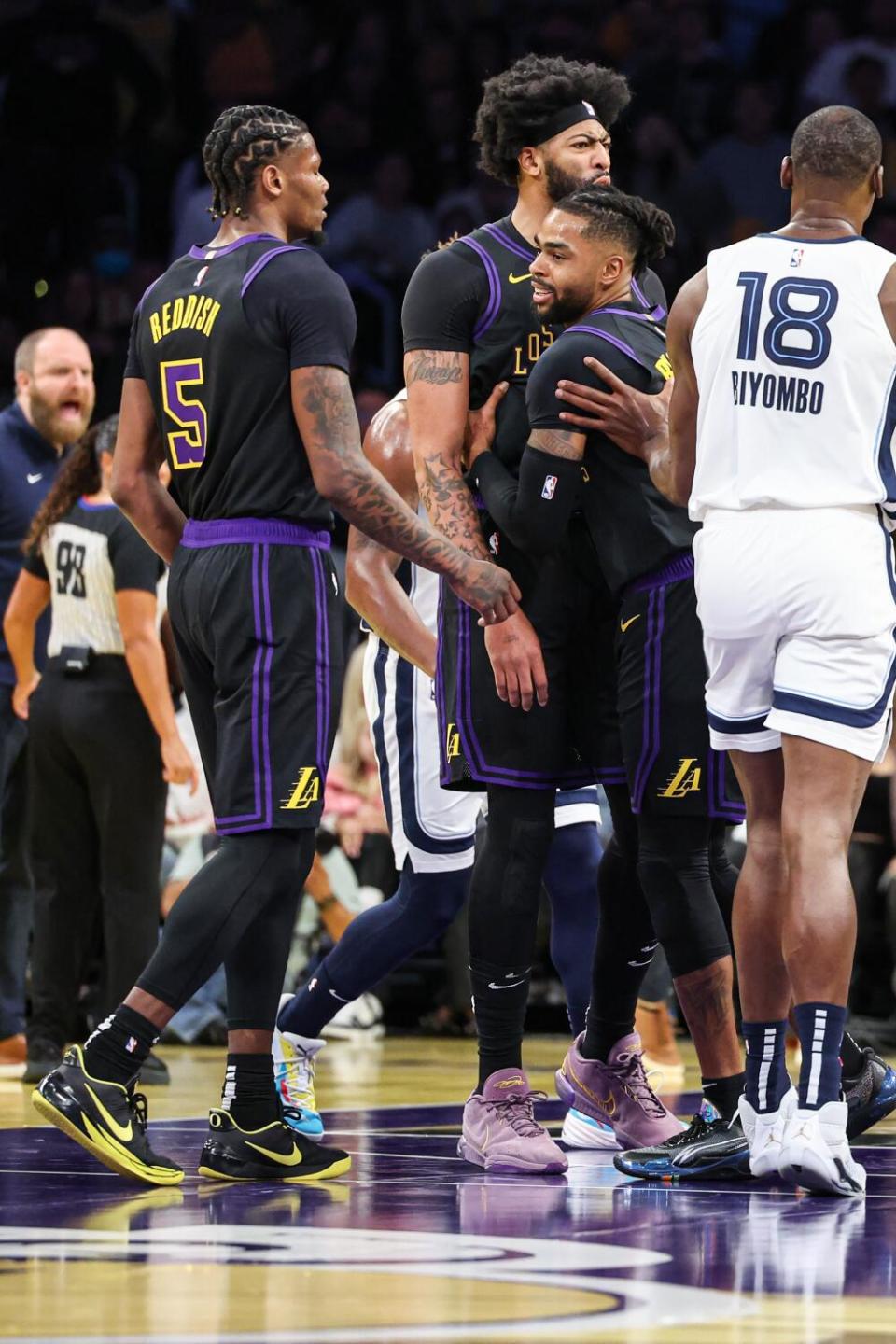 Anthony Davis is held back by teammate D'Angelo Russell after getting into an altercation with Memphis' Santi Aldama.