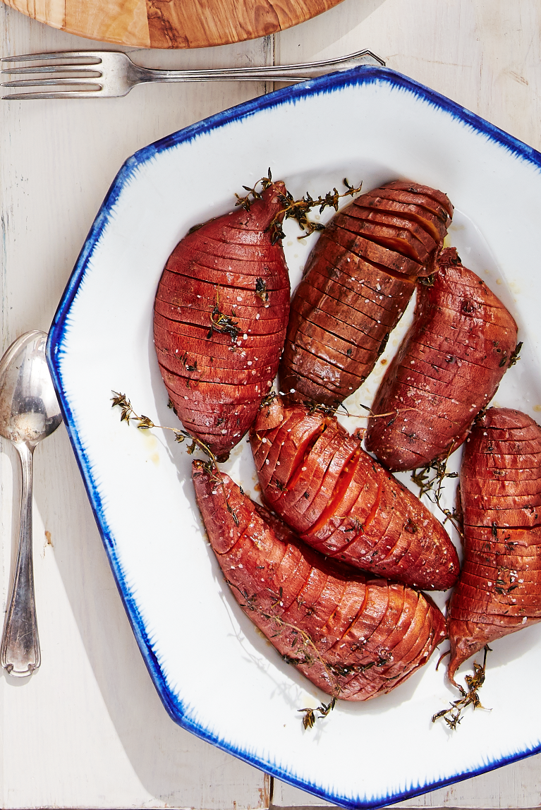 <p>These simply seasoned hasselback sweet potatoes are rich and sweet without being overbearing.</p><p><strong><a href="https://www.countryliving.com/food-drinks/a28942812/roasted-hasselback-sweet-potatoes-recipe/" rel="nofollow noopener" target="_blank" data-ylk="slk:Get the recipe;elm:context_link;itc:0;sec:content-canvas" class="link ">Get the recipe</a>.</strong></p><p><strong><a class="link " href="https://www.amazon.com/Nordic-Ware-Natural-Aluminum-Commercial/dp/B0064OM53G/?tag=syn-yahoo-20&ascsubtag=%5Bartid%7C10050.g.33370793%5Bsrc%7Cyahoo-us" rel="nofollow noopener" target="_blank" data-ylk="slk:SHOP BAKING SHEETS;elm:context_link;itc:0;sec:content-canvas">SHOP BAKING SHEETS</a><br></strong></p>