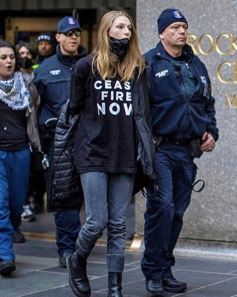 Hunter in protest with 'CEASE FIRE NOW' shirt being escorted by police