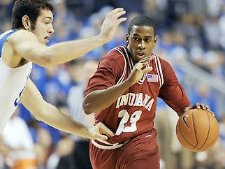 Kentucky’s Josh Harrellson (left) defends a drive in the lane by Indiana’s Devan Dumes during the second half Saturday at Rupp Arena in Lexington, Ky. Harrellson had a team-high 15 points in the Wildcats’ 72-54 win.Chris Howell | Herald-Times