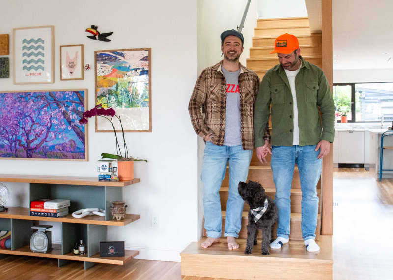 Couple standing on stairs in newly renovated home.