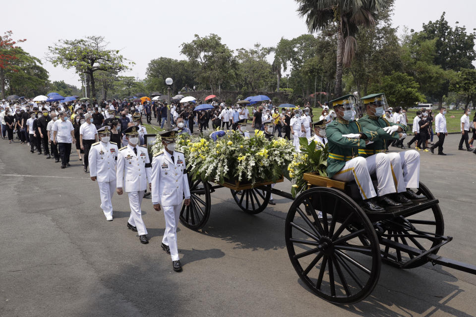 Honor guards transport the urn of former Philippine President Benigno Aquino III during state burial rites on Saturday, June 26, 2021 at a memorial park in suburban Paranaque city, Philippines. Aquino was buried in austere state rites during the pandemic Saturday with many remembering him for standing up to China over territorial disputes, striking a peace deal with Muslim guerrillas and defending democracy in a Southeast Asian nation where his parents helped topple a dictator. He was 61. (AP Photo/Aaron Favila)