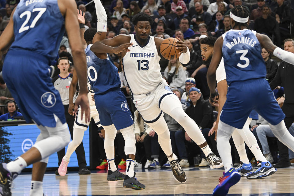 Memphis Grizzlies forward Jaren Jackson Jr. (13) collides with Minnesota Timberwolves guard Mike Conley as he drives to the basket during the first half of an NBA basketball game Wednesday, Feb 28, 2024, in Minneapolis. (AP Photo/Craig Lassig)