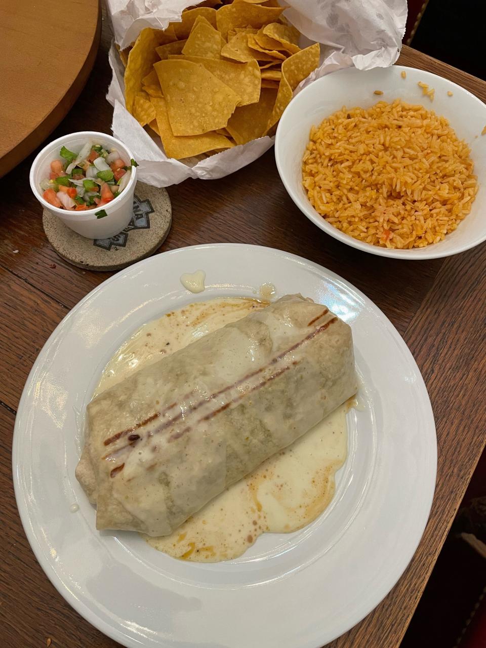 A 54-year-old Fayetteville pharmacist eats a burrito with pico de gallo, chips and rice from MiCasita Mexican Restaurant, a regional chain.