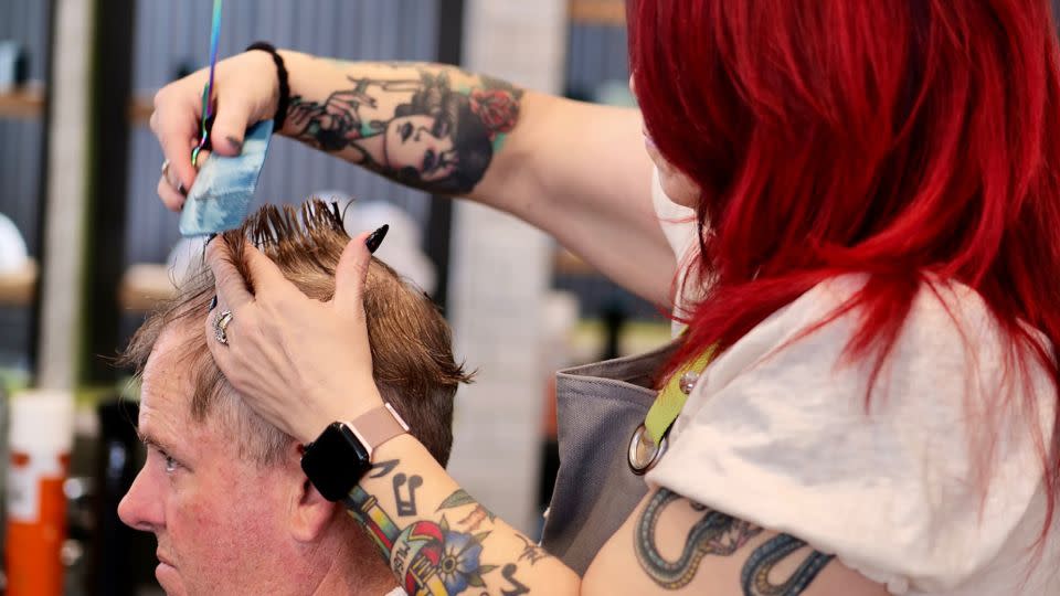 A barber cuts hair at R&R Hair Labs. - Courtesy R&R Head Labs