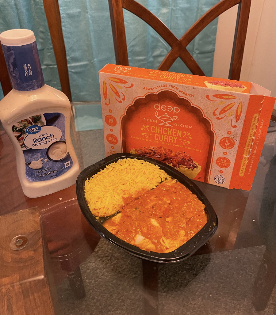 microwave chicken curry dinner with a ranch bottle next to it