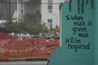 A painted bible verse is seen inside of what is left of a building on March 22, 2024, that was destroyed by a deadly tornado in March 2023 in Rolling Fork, Miss. One year after the deadly tornado struck, buildings throughout town remain boarded up, and the remnants of destroyed properties dot the landscape. The tornado killed 14 residents and reduced the town to rubble as it charted a merciless path across one of the country’s poorest regions. (AP Photo/Rogelio V. Solis)