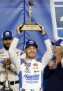 Kyle Larson, center, celebrates in Victory Lane after winning a NASCAR Cup Series auto race at Kansas Speedway in Kansas City, Kan., Sunday, May 5, 2024. (AP Photo/Colin E. Braley)