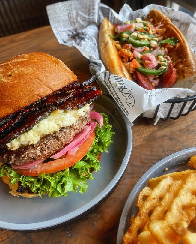 Among the items on the new Trolley Tap House menu: The "Donkey Kong" smash burger, the banh mi dog topped with banh mi vegetable "relish,” scallion chili mayonaise, jalapeños,
peanuts, cilantro and crispy shallots and waffle fries