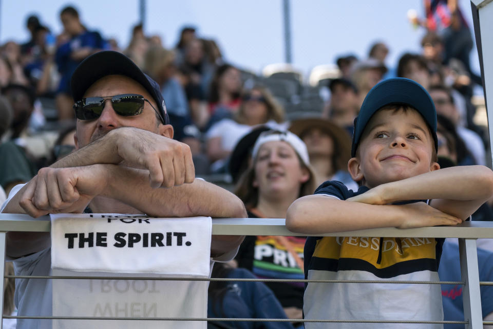 Washington Spirit fans watch an NWSL soccer match against the San Diego Wave on Saturday, May 6, 2023, in Washington. (AP Photo/Nathan Howard)