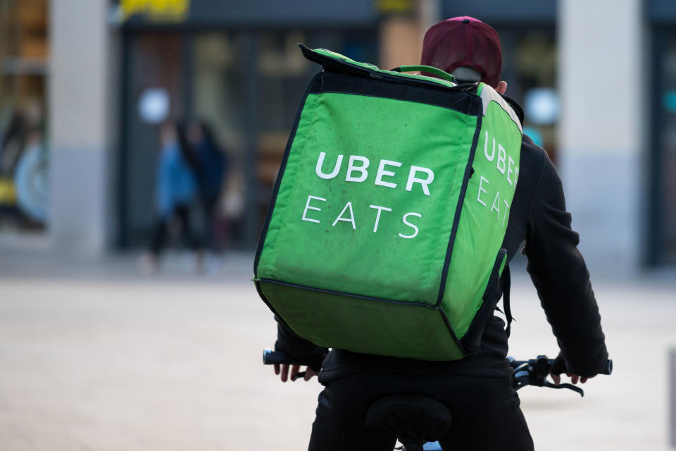 A Uber Eats worker rides a bike through the city centre in Cardiff, United Kingdom. 