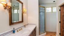 The main-bedrooms ensuite has his and hers sinks large sandstone bath and shower.