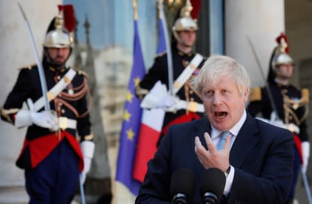 British Prime Minister Boris Johnson delivers a joint statement with French President Emmanuel Macron before a meeting on Brexit at the Elysee Palace in Paris