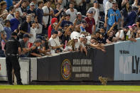 Fans cheer as a security guard holds a door open so that a cat that entered the field in the eighth inning of a baseball game between the New York Yankees and the Baltimore Orioles can exit, Monday, Aug. 2, 2021, in New York. (AP Photo/Mary Altaffer)