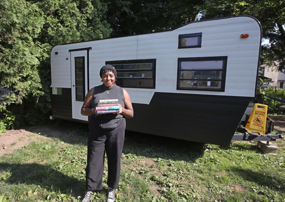 Taylor Thomas stands with a trailer that will be the rolling home of her bookstore, Archivist Books, in July..