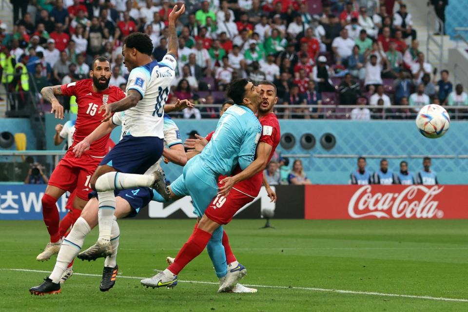 Iran's Alireza Beiranvand collides into Majid Hosseini resulting in being substituted off with a concussion injury (Reuters)