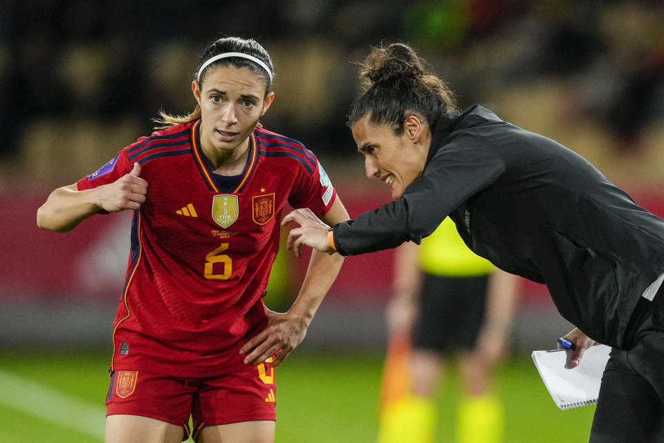 FILE - Spain's coach Montserrat Tome, right, gives instructions to Spain's Aitana Bonmatí during the women's Nations League semi finals soccer match between Spain and Netherlands, at La Cartuja stadium in Seville, Spain, Friday, Feb. 23, 2024. Spain can become the first team to win an Olympics after a World Cup title. (AP Photo/Jose Breton, File)