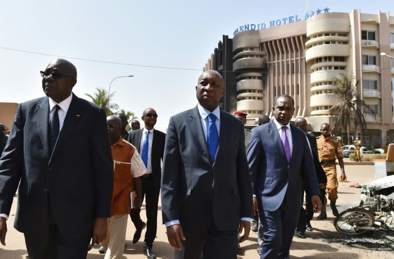 Malian Prime Minister Modibo Keita (L), Burkina Faso's Prime Minister Paul Kaba Thieba (C) and Foreign Minister Alpha Barry leave after visiting the Splendid Hotel in Ouagadougou on January 17, 2016, following a jihadist attack