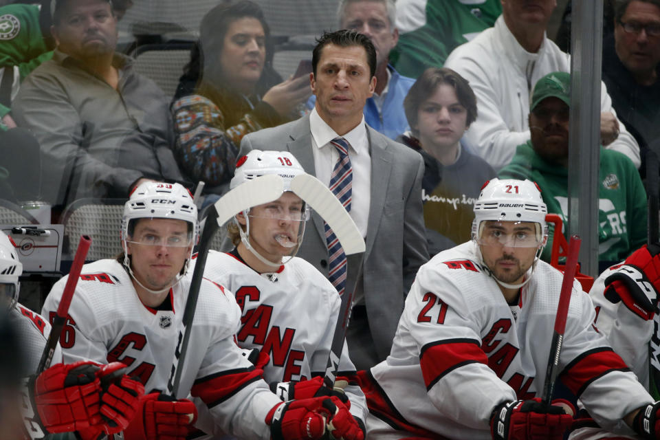 Carolina Hurricanes head coach Rod Brind'Amour watches his team play the Dallas Stars with left wing Erik Haula (56) center Ryan Dzingel (18) and right wing Nino Niederreiter (21) during the first period of an NHL hockey game in Dallas, Tuesday, Feb. 11, 2020. (AP Photo/Michael Ainsworth)