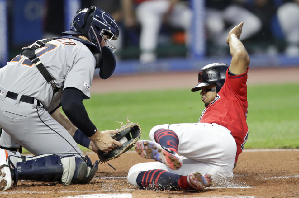 Cleveland Indians' Francisco Lindor, right, scores ahead of the tag from Detroit Tigers catcher Grayson Greiner in the first inning in a baseball game Thursday, Sept. 19, 2019, in Cleveland. (AP Photo/Tony Dejak)