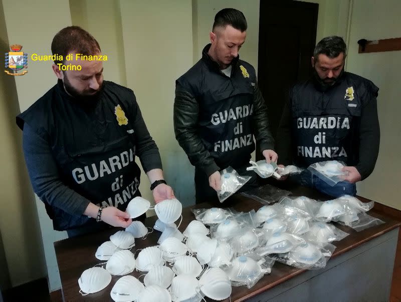 Italian finance police check protective masks that were seized because they were being sold for exorbitant prices by Italian companies, in Turin