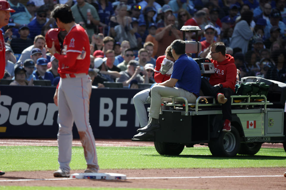 TORONTO, ON - JULY 29  -   Los Angeles Angels designated pitcher Shohei Ohtani (17) watches as Los Angeles Angels left fielder Taylor Ward (3) is carted off the field after being hit by a pitch as the Toronto Blue Jays play the Los Angeles Angels  at Rogers Centre in Toronto. July 29, 2023.        (Steve Russell/Toronto Star via Getty Images)