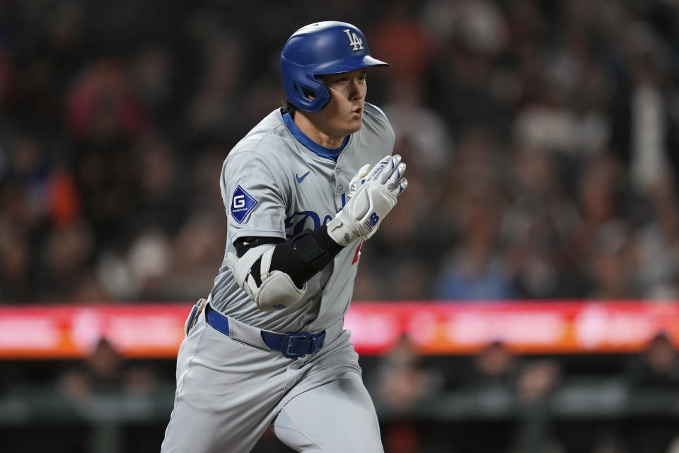 Los Angeles Dodgers' Shohei Ohtani runs to first on his single against the San Francisco Giants during the eighth inning of a baseball game Friday, June 28, 2024, in San Francisco. (AP Photo/Godofredo A. Vásquez)