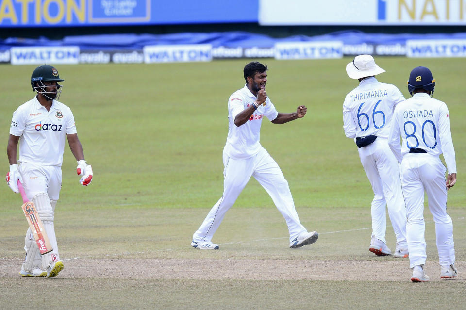 Sri Lanka bowler, Ramesh Mendis, second left, celebrates the wicket of Bangladeshi batsman, Tamim Iqbal, left during the fourth day of the second test cricket match between Sri Lanka and Bangladesh in Pallekele, Sri Lanka, Sunday, May 2, 2021. ( AP Photo/Sameera Peiris)