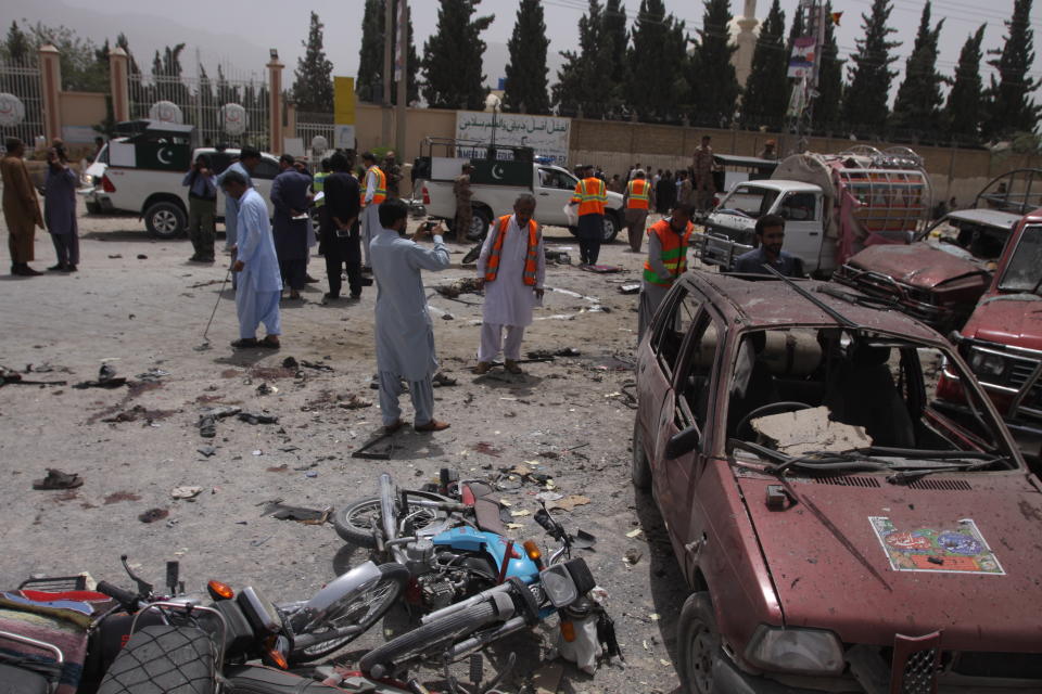 FILE - In this July 25, 2018, file photo, Pakistani security officials visit the site of a suicide bombing which killed dozens of people as Pakistanis cast ballots in a general election in Quetta, Pakistan. Counterterrorism department chief, Pervez Ahmed Chandio, said the Islamic State group is the newest and deadliest front in Pakistan's decades-old war on terror. "It is one of the most dangerous threats facing Pakistan and we are ready to fight this war," he said. (AP Photo/Arshad Butt, File)