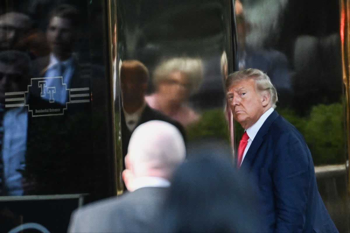 Former US president Donald Trump walking into Trump Tower in New York in April. The fraud lawsuit against him risks bringing down his business empire  (AFP via Getty Images)