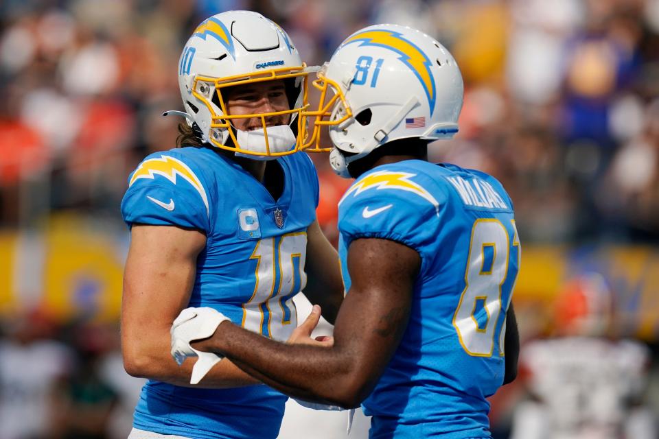 Los Angeles Chargers quarterback Justin Herbert, left, celebrates his touchdown throw to wide receiver Mike Williams (81) last season. Herbert is one of the league's bright young stars. (AP Photo/Gregory Bull)