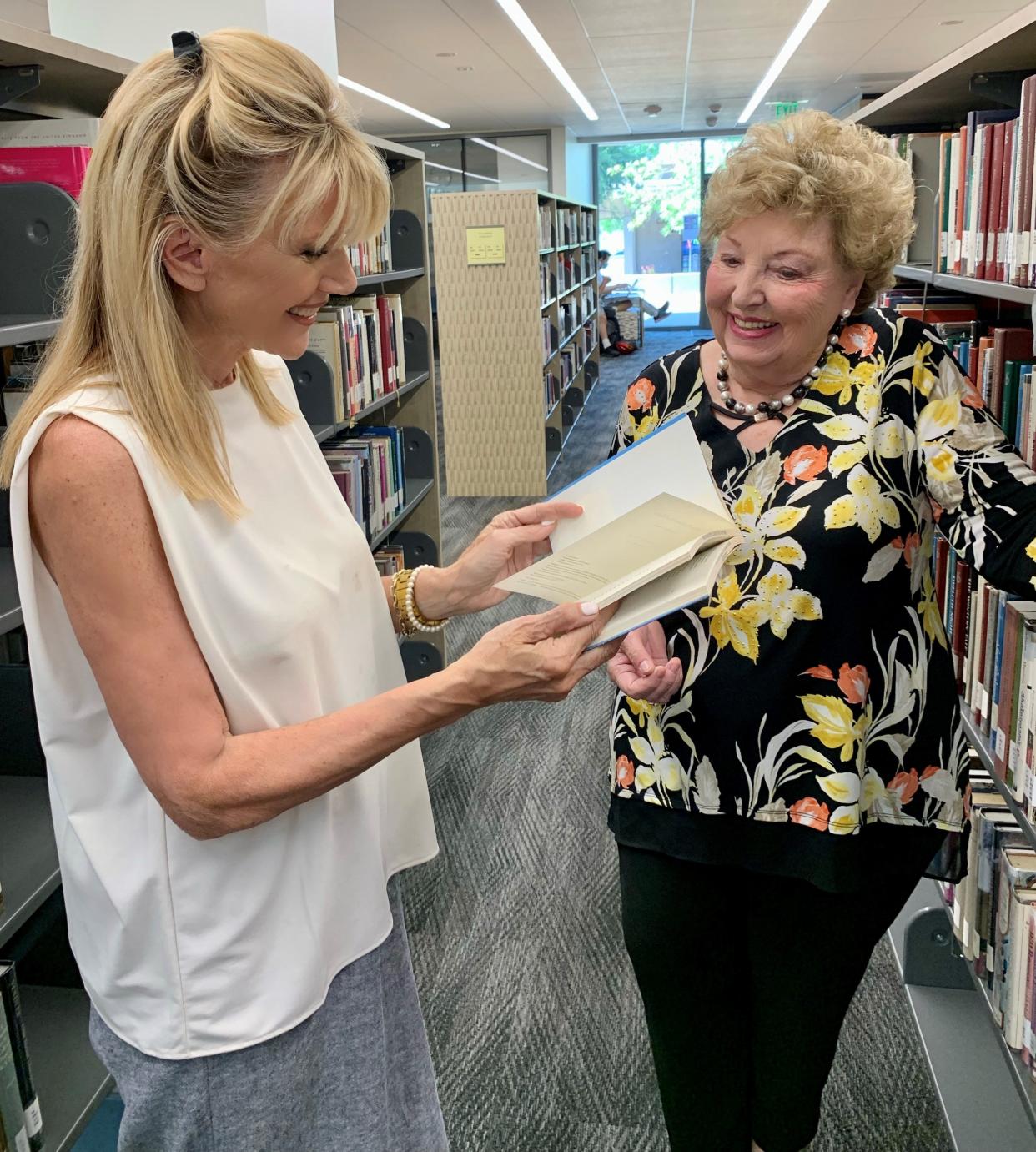 Sandie Newton speaks with Laura Lee Marcarian at the College of the Desert library.