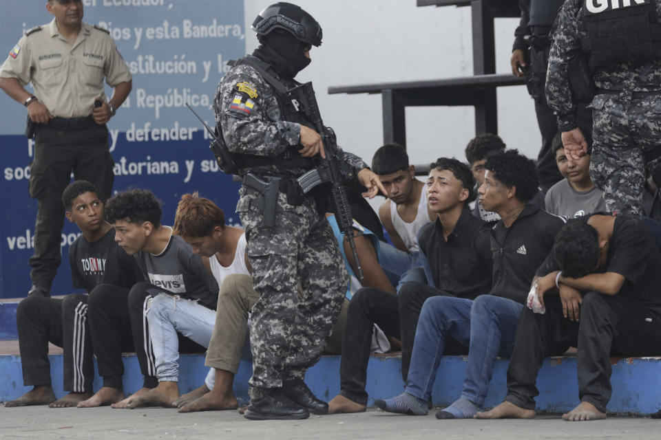 Police present to the press arrested men who the police identify as the previous day's attackers on the TC Television station, at police headquarters in Guayaquil, Ecuador, Wednesday, Jan. 10, 2024. No one was killed in Tuesday’s attack and authorities say 13 attackers were arrested and would be charged with terrorism. (AP Photo/Cesar Munoz)