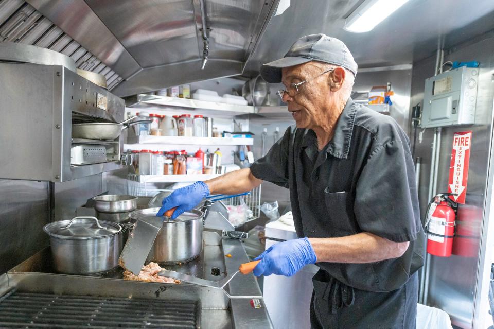 Steel City Café Chef Harvey Claybrook prepares a applewood smoked pork sandwich for a customer at Walter's Brewery on Tuesday, May 2, 2023, in Pueblo, Colo. Claybrook recently had to replace a generator used for his food truck after it was stolen.