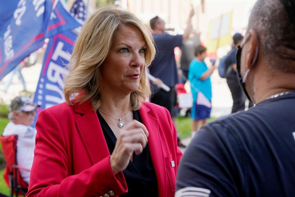 Dr. Kelli Ward, left, chair of the Arizona Republican Party, talks with a supporter of President Donald Trump as they join the crowd at a rally outside the Arizona Capitol, Nov. 7, 2020 (AP)